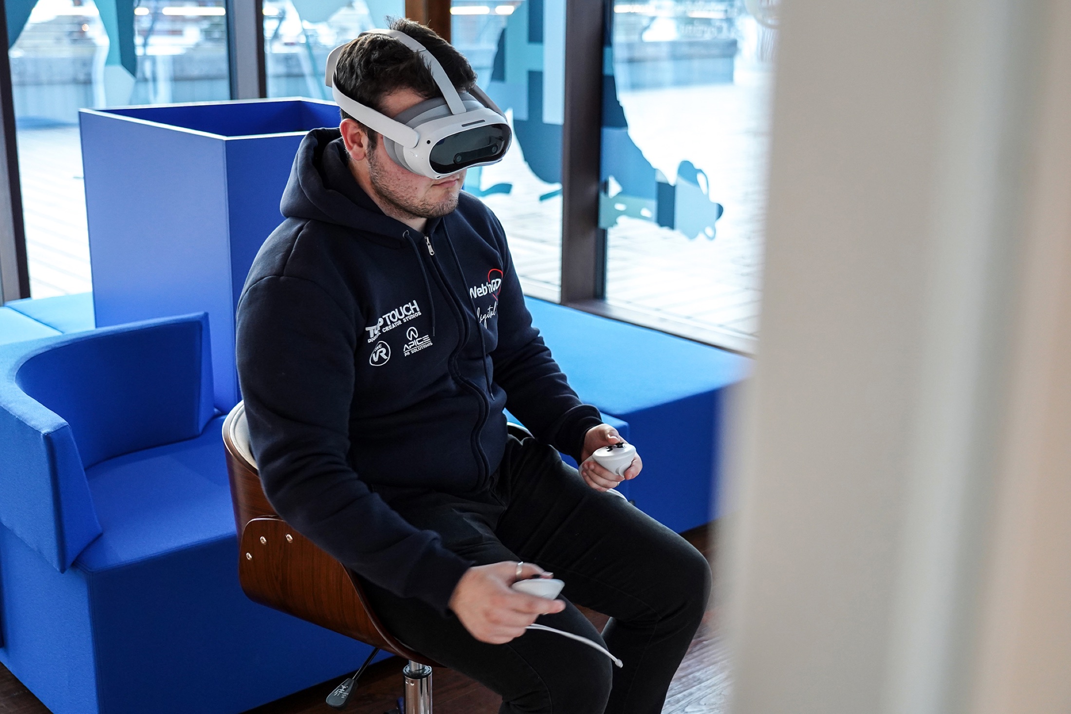 Visitor wearing a VR headset and holding controllers
