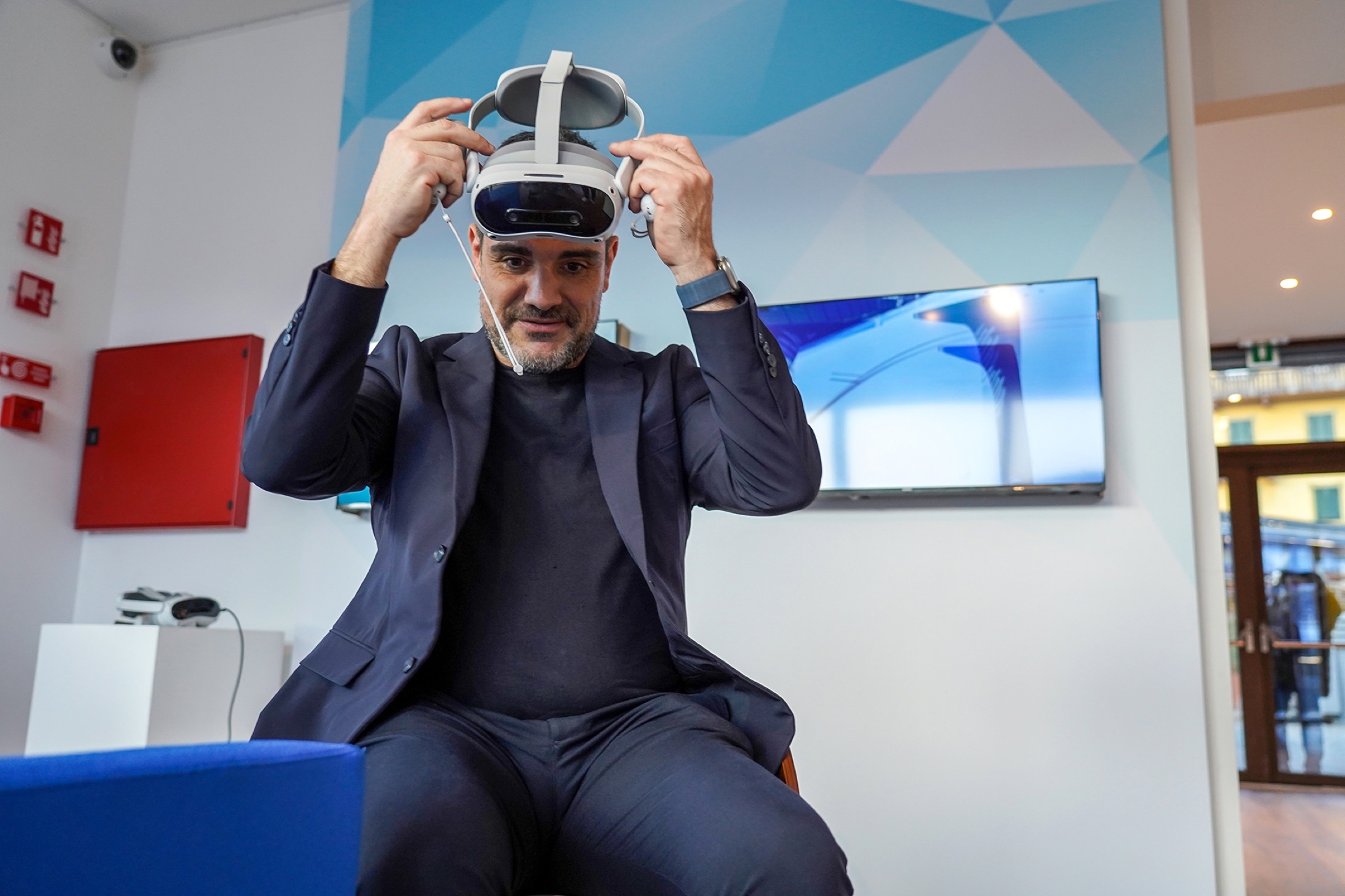 Guest wearing a VR headset in front of the screen